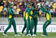 WELLINGTON, NEW ZEALAND - FEBRUARY 25:  Andile Phehlukwayo of South Africa is congratulated by teammates Faf du Plessis and Quinton de Kock after taking the wicket of Kane Williamson of New Zealand during game three of the One Day International series between New Zealand and South Africa at Westpac Stadium on February 25, 2017 in Wellington, New Zealand.  (Photo by Hagen Hopkins/Getty Images)